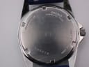 Close-up of the stainless steel case back of the Seiko V743-9A20, showing model number, serial number, and "water resistant 10 bar".