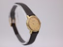 Angled side view of the Tissot C226K, highlighting the gold case and textured brown leather strap.
