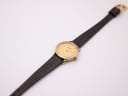 Overhead view of the Tissot watch on its long brown lizard-effect leather strap.