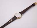 Back view of the Tissot watch, showing the stainless steel case back and the 'PRISMA' brand on the strap.