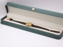 The Tissot watch displayed in a generic green leatherette presentation box.