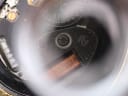 Magnified close-up of the quartz movement showing "Swiss Made" engraving and other details.