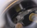 Further magnified view of the quartz movement, showing "7 Jewels Unadjusted" text and other movement markings.