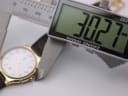 Digital caliper measuring the case diameter of the watch, displaying 30.27mm.