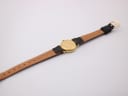 Rear view of the Raymond Weil watch and strap, revealing the case back and the lighter brown underside of the leather.