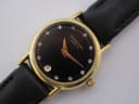 Close-up front view of the Raymond Weil 9923 watch dial, clearly showing the black face, stone-set markers, gilt hands, and date window at 6 o'clock.