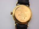 Close-up of the Raymond Weil watch case back, with engravings 'RAYMOND WEIL GENEVE 18 K GOLD ELECTROPLATED WATERRESISTANT 10 M 9923' visible.