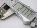 Digital caliper measuring the case diameter of the Raymond Weil watch, displaying an exact measurement of 21.77 mm.
