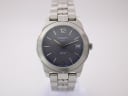 Front view of Tissot PR 50 watch with blue sunburst dial, stainless steel case, and bracelet on a white background.