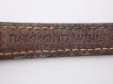 Close-up of the underside of the black leather strap, showing 'RAYMOND WEIL' embossed text.