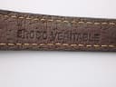 Close-up of the underside of the black leather strap, showing 'CROCO VERITABLE' embossed text.
