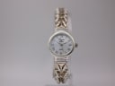 Front view of Precious Time watch with silver-tone case and braided bracelet