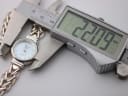 Digital caliper measuring the watch case diameter at 22.09mm