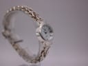 Another angled side view of Precious Time watch on display stand, showing bracelet texture