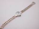 Overhead view of the entire Precious Time watch laid flat, showing the full braided bracelet