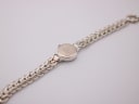 Back view of the Precious Time watch laid flat, showing the case back engraving and full bracelet