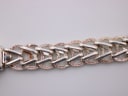 Close-up of the silver-tone braided bracelet links