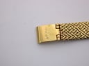 Close-up of the gold-tone fold-over clasp on the mesh bracelet, showing the engraved 'ROTARY' logo.