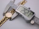 Digital caliper measuring the Christian Dior watch case diameter, displaying 25.21mm.
