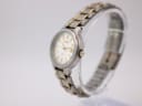 Oblique view of the Seiko women's watch, highlighting the brushed titanium case and gold-tone accents on the integrated bracelet.