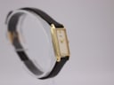 Another angled side view of the Seiko watch, highlighting the rectangular case and brown strap.