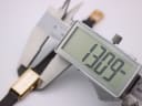 Digital caliper measuring the case width of the Seiko watch at 13.09mm.