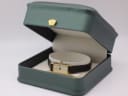 The Seiko watch displayed in a green leatherette presentation box.