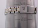 Close-up of the Tissot PR 50 bracelet wrapped around a wrist sizing gauge, indicating a wrist circumference of approximately 164mm / 16.4cm.