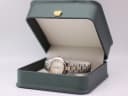 The Tissot PR 50 watch presented in a generic green leatherette display box, a studio prop used for photography.