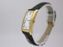 Side angled view of the Maurice Lacroix watch, showing the curved gold-plated case and signed crown.