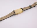 Close-up of the watch case back and inner strap, showing "15 lézard veritable" text and lug area.