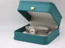 Maurice Lacroix watch presented in a green leatherette display box with a gold crown emblem.