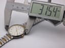 Digital caliper measuring the Tissot Seastar watch case diameter, showing 31.54mm on the display.