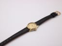 Full view of the Zenith watch with black leather strap on a white background.