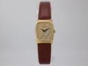 Front view of Raymond Weil 5744 ladies quartz watch with gold rectangular case and striped multi-tone dial on a white display stand.