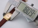 Digital caliper measuring the width of the Raymond Weil 5744 watch case, displaying 18.79mm.