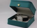 The XEN watch displayed in a green leatherette presentation box (studio prop).