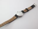 Back view of the XEN watch and strap laid flat, showing the case back engravings and strap reverse.