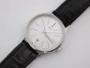 Close-up front view of the XEN white dial, showing baton indices, date window, and blue seconds hand.