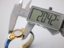 Digital caliper measuring the case diameter of the watch, displaying an exact measurement of 20.42mm.