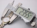 Digital caliper measuring the Certina watch case diameter at 23.55mm, with the watch face visible in the background.