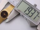 Digital caliper measuring the case diameter of the Zenith watch at 19.37mm.