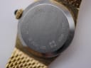 Close-up of the Zenith watch case back with model number 12.0030.055 and material engravings.