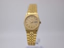 Front view of a gold-tone octagonal Seiko 2A23-0020 quartz watch with a champagne dial and integrated bracelet.