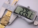 Digital caliper measuring the case diameter of the Seiko watch at 22.61mm.