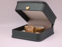 The gold-tone Seiko watch presented within a generic green display box (studio prop).