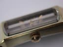 Top-down view of the watch case measured with a digital caliper, displaying a width of 12.33mm.