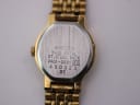 Close-up of the watch case back, showing "SEIKO BASE METAL ST.STEEL BACK V401-0281" and serial number.