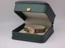 The gold-tone Seiko watch resting in a green display presentation box.