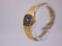 Angled view of the gold tone Seiko watch, showing the textured case and crown on the right side.